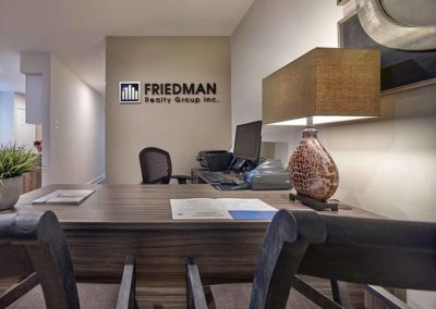 Leasing office with a large desk and Friedman Realty Group sign