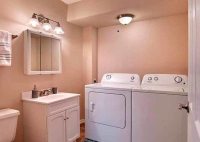 In-unit washer and dryer side by side next to bathroom sink in apartment for rent in Prospect Park, PA