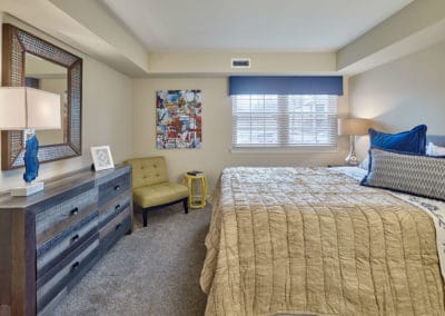 Large window lets in plenty of natural light to spacious, carpeted bedroom
