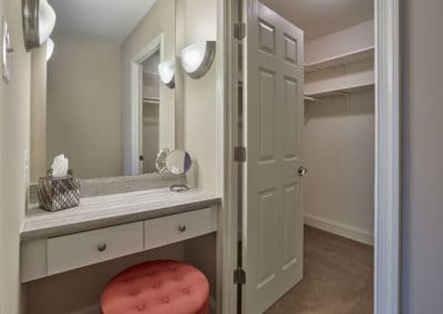 Walk-in closet next to built-in vanity with large mirror in Lansdale, PA apartment for rent