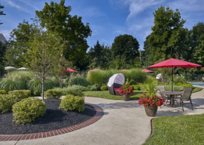 Garden lounge area with seating and beautiful landscaping at Willowyck Apartments