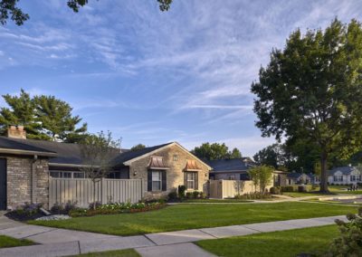 Exterior of ranch-style apartments surrounded by sidewalks and well-kept grass