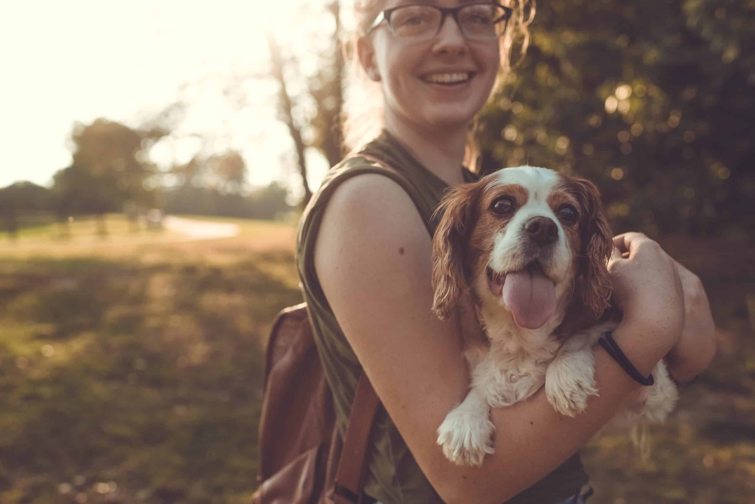 girl holding her dog