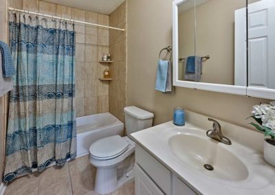 Large bathroom with tiled shower and sink with vanity