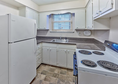 Cozy kitchen space with tiled floors at Gladmar Court Apartments