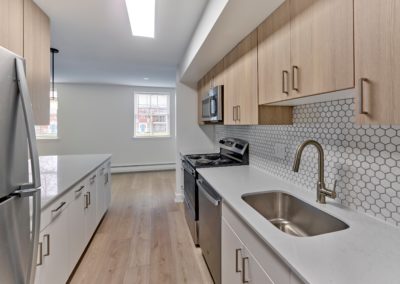 Kitchen with stainless steel appliances and designer tile backsplash at Brookdale Apartments