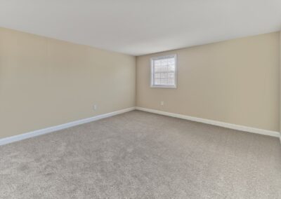 Spacious Bedroom with carpeted flooring at Woods Edge apartments