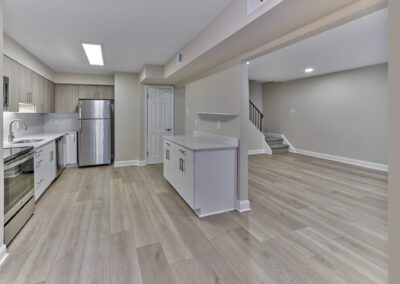 Spacious kitchen and living area with hardwood-style floors at Woods Edge apartments
